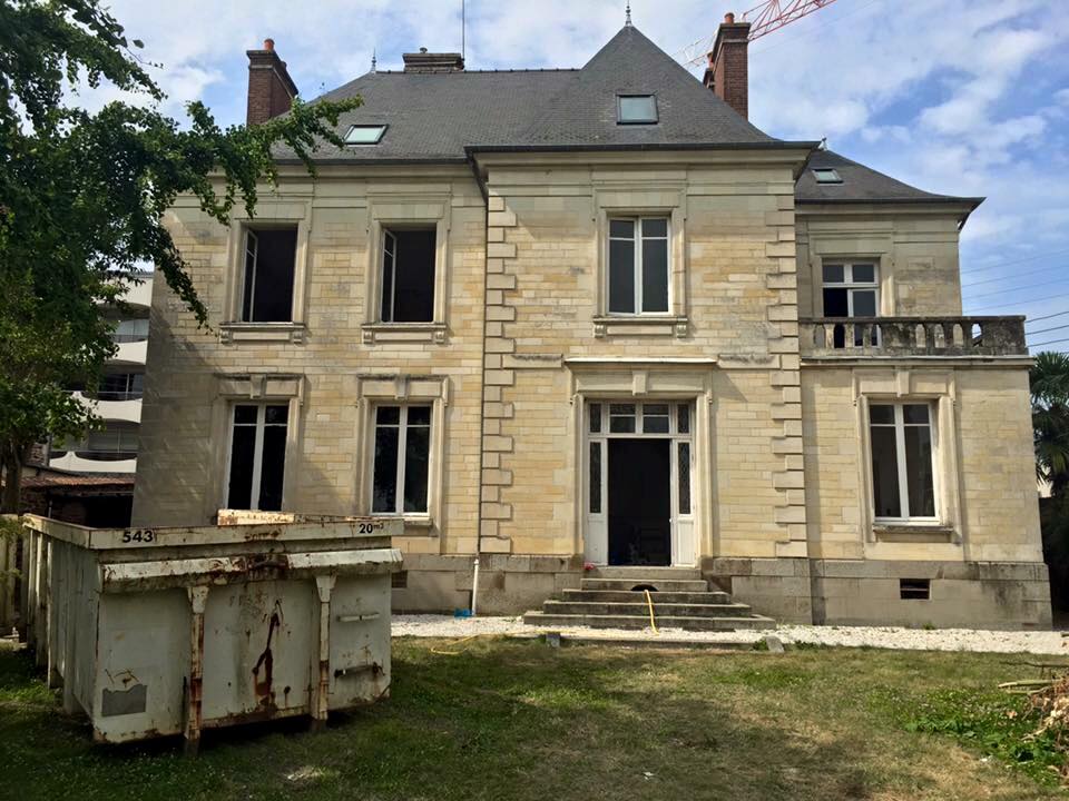 Rénovation complète d’une maison bourgeoise dans le centre de Dinard Vue de l'extérieur d'une grande et ancienne maison bourgeoise en pierre de taille, avec une toiture en ardoise, en cours de rénovation.